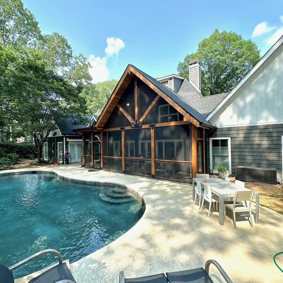 Timber gable screened porch overlooking a pool
