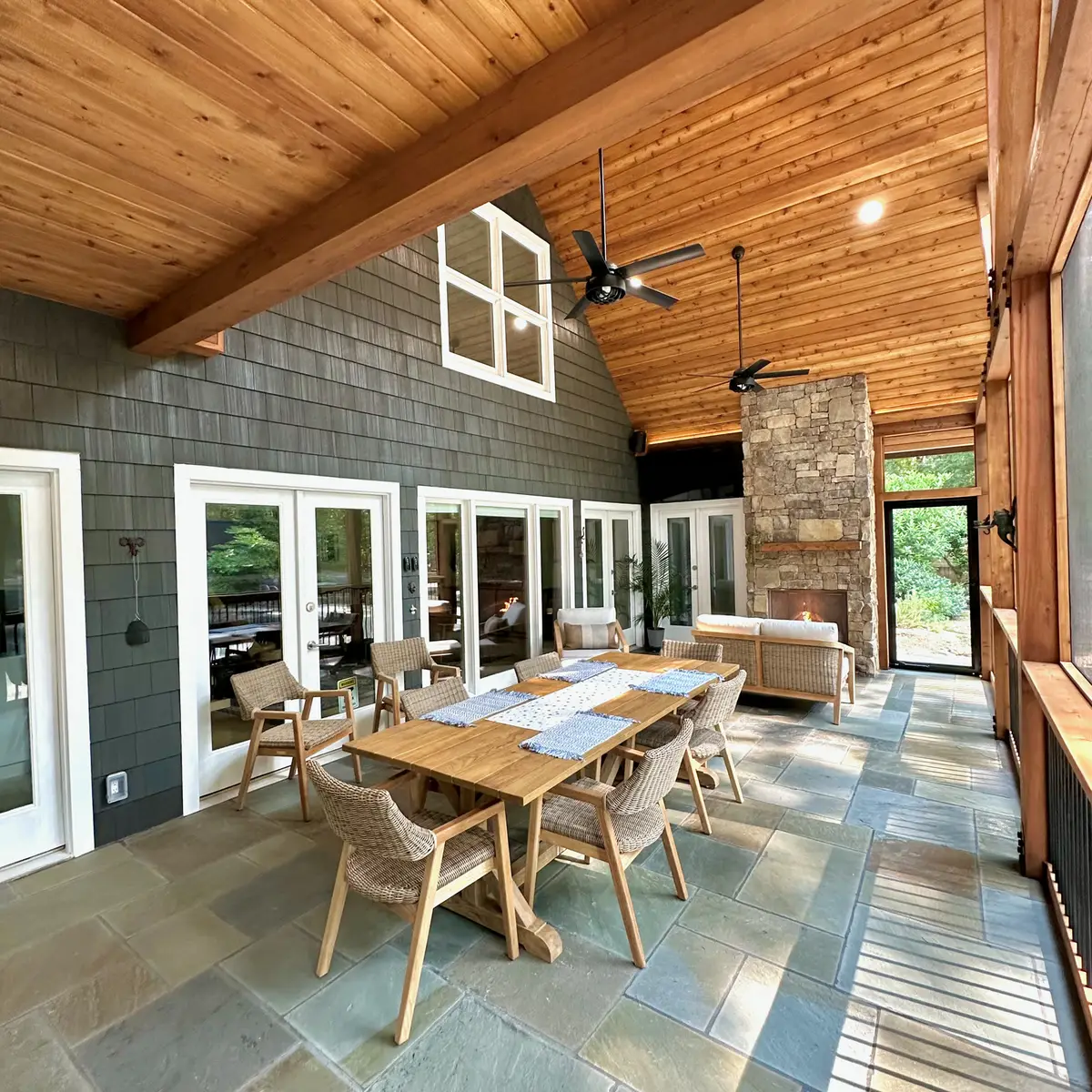 Screened porch with cedar vaulted ceiling and stone fireplace