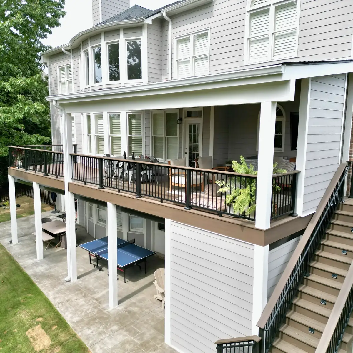 Elevated view of the Smyrna covered deck and stairs above the dry lower patio