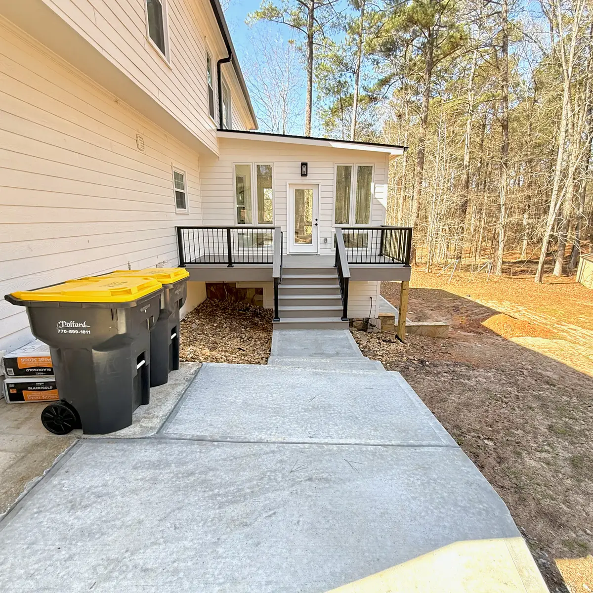 Small composite deck landing with stairs to a concrete walkway