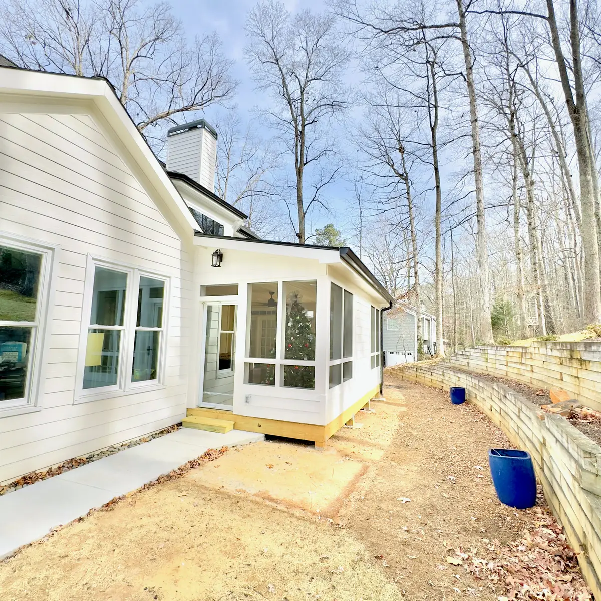 Sunroom addition exterior with white trim and windows