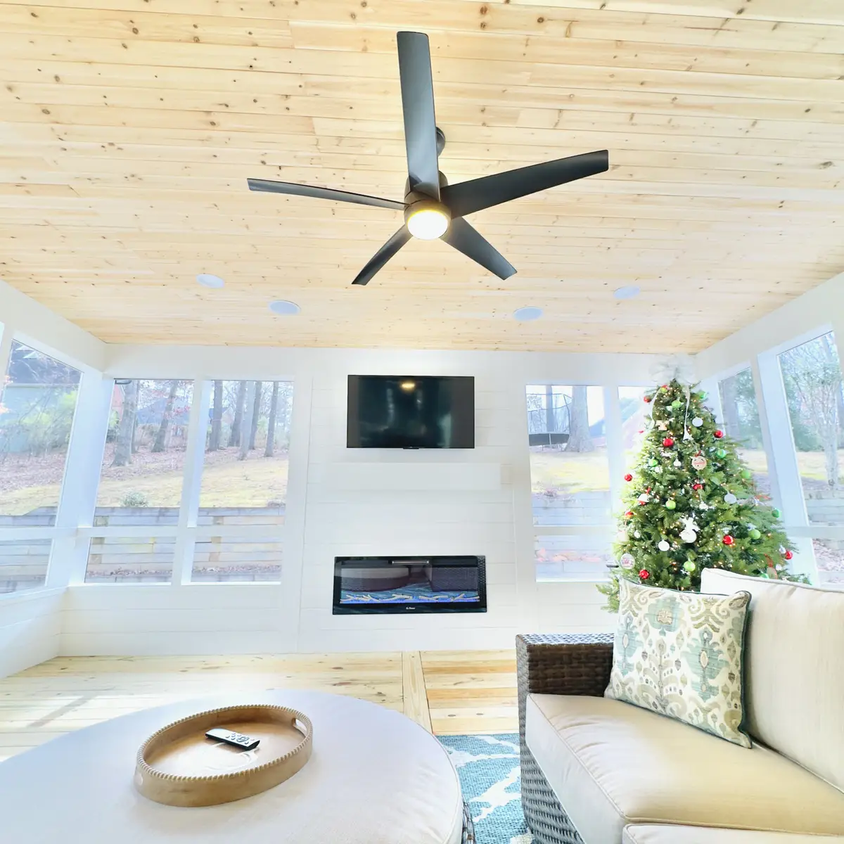 Sunroom with pine ceiling, fan, TV and linear fireplace