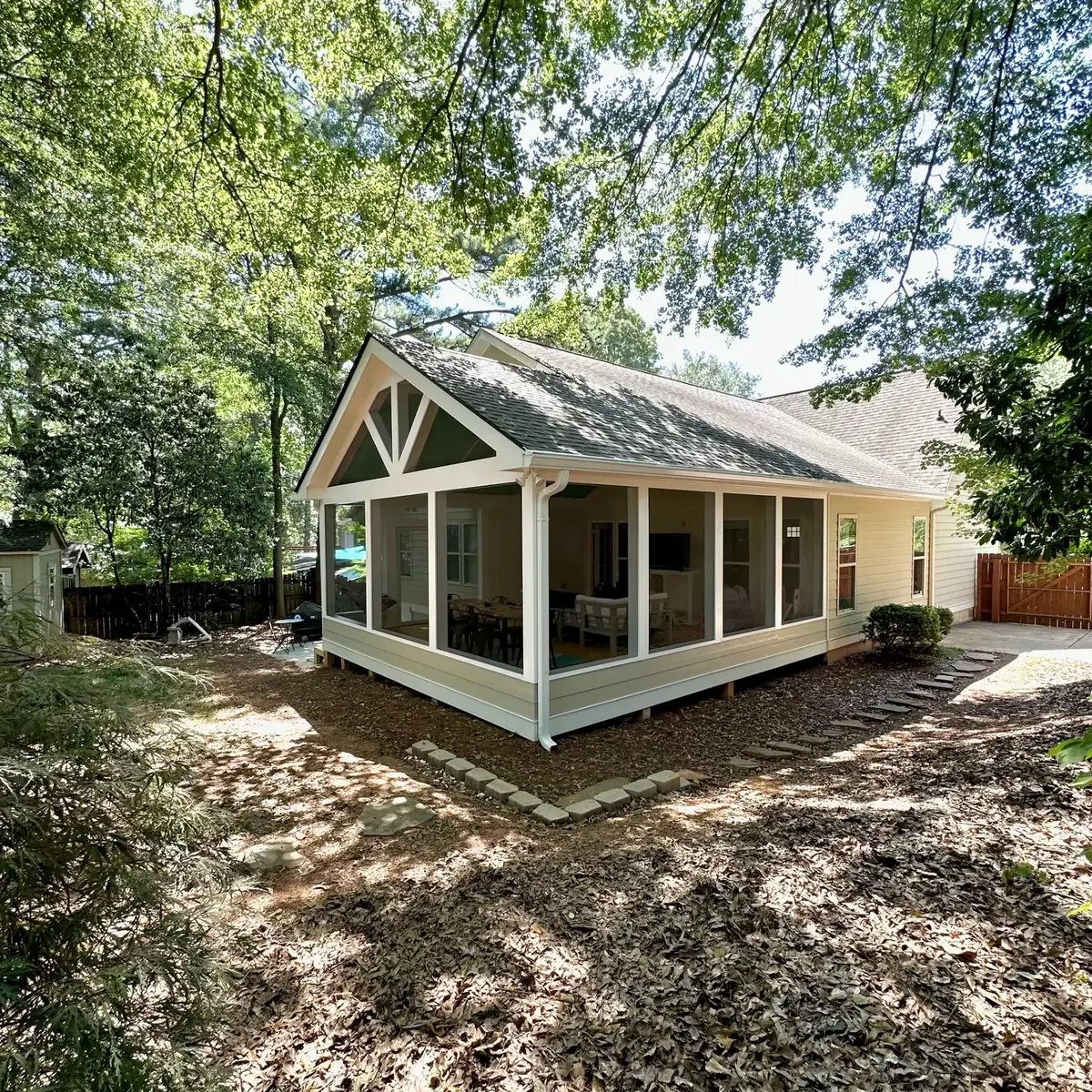 Atlanta screen room addition with gabled screened porch, matching siding and stamped concrete pad