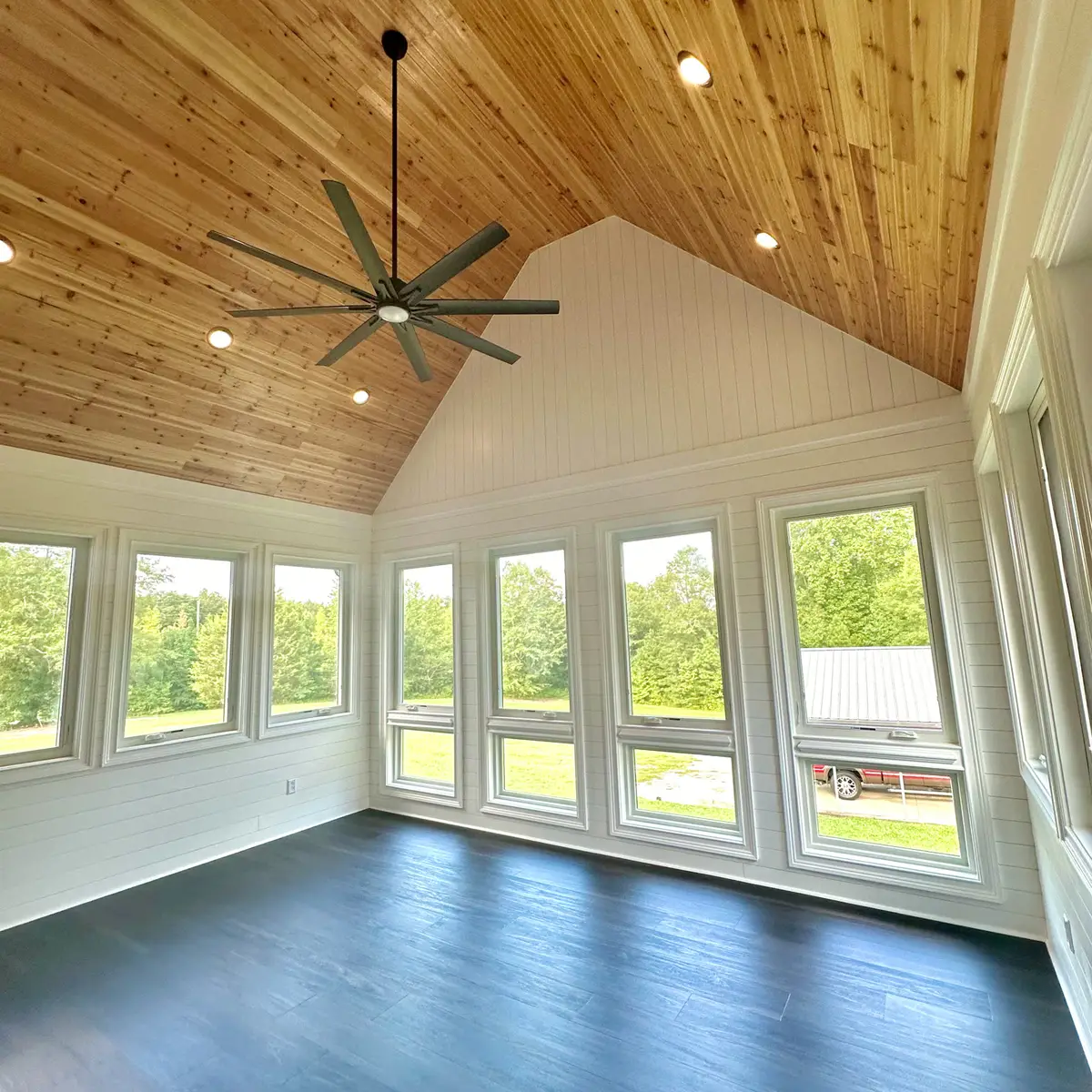 Vaulted cedar-ceiling sunroom with many windows