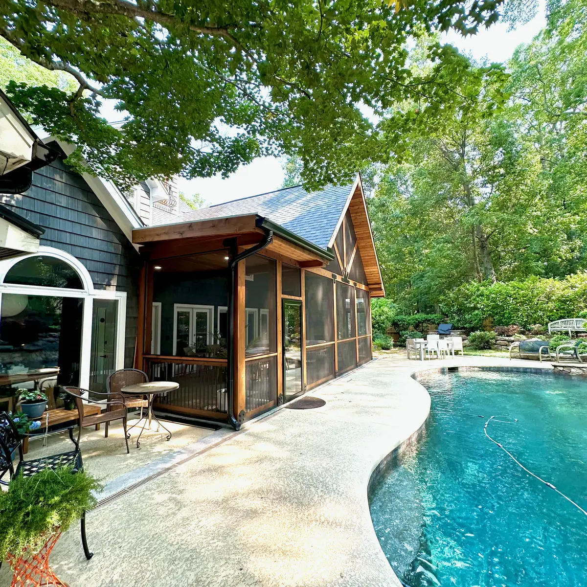 Timber screened porch with pool and flagstone patio