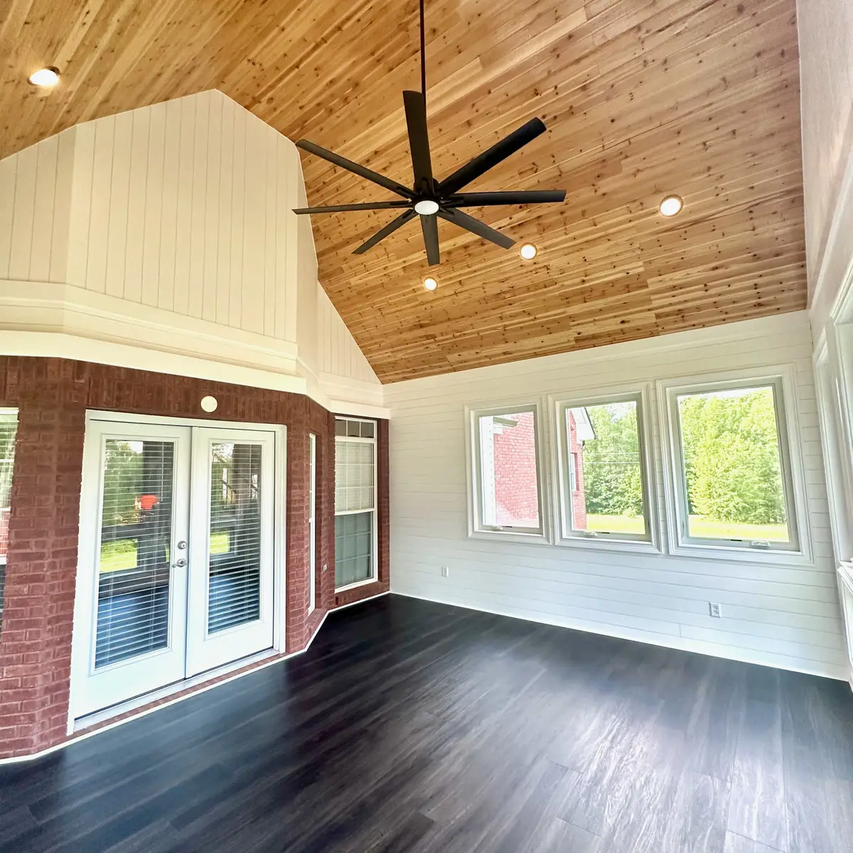 Sunroom with vaulted cedar ceiling and French doors