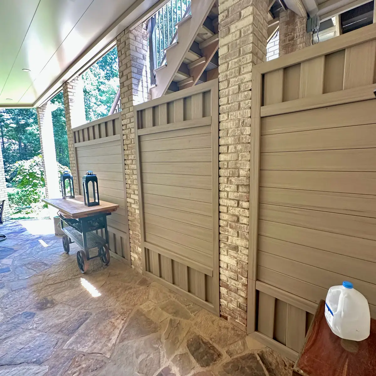 Under-deck flagstone patio with privacy screen