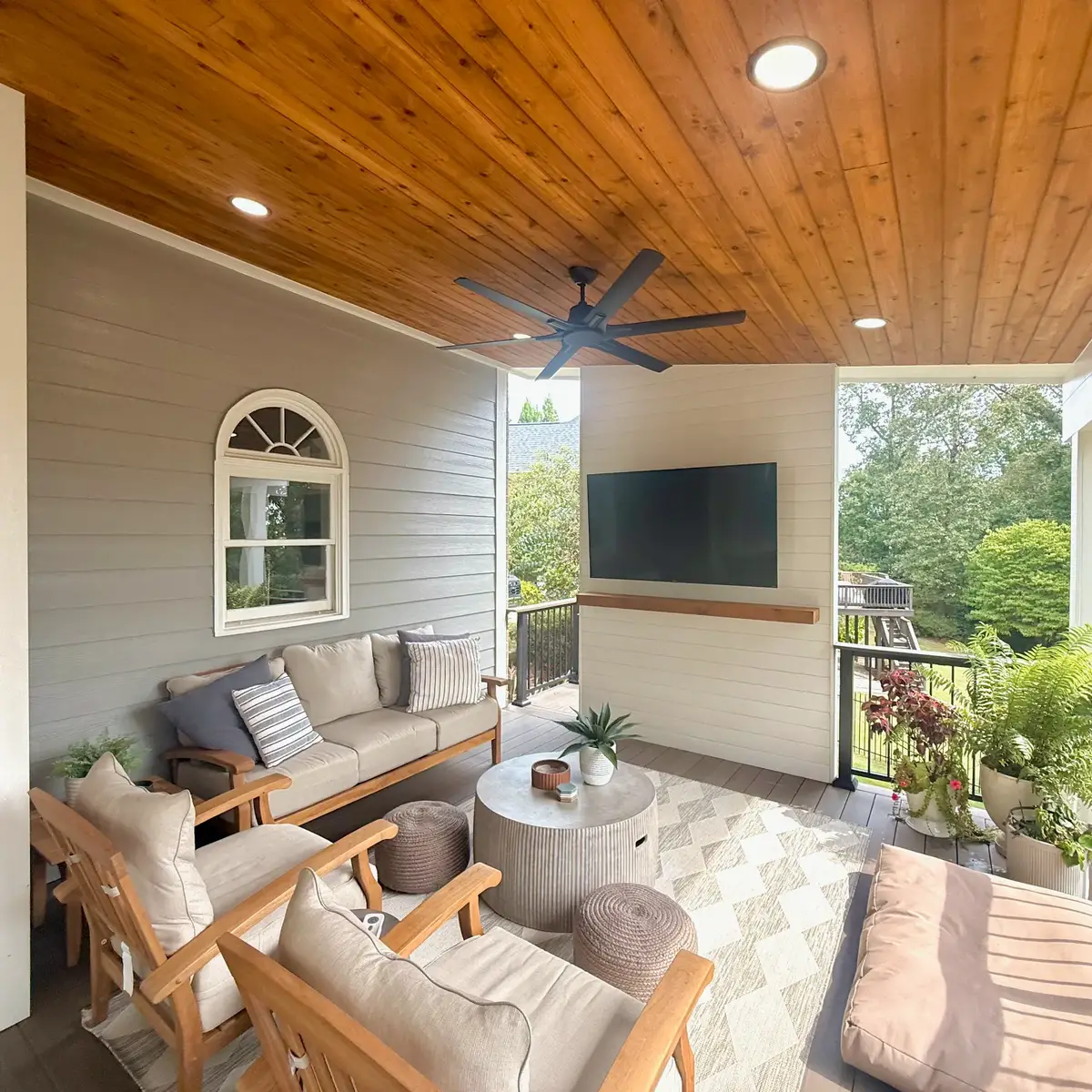 Smyrna covered porch lounge with cedar ceiling, shiplap television wall and floating cedar mantle