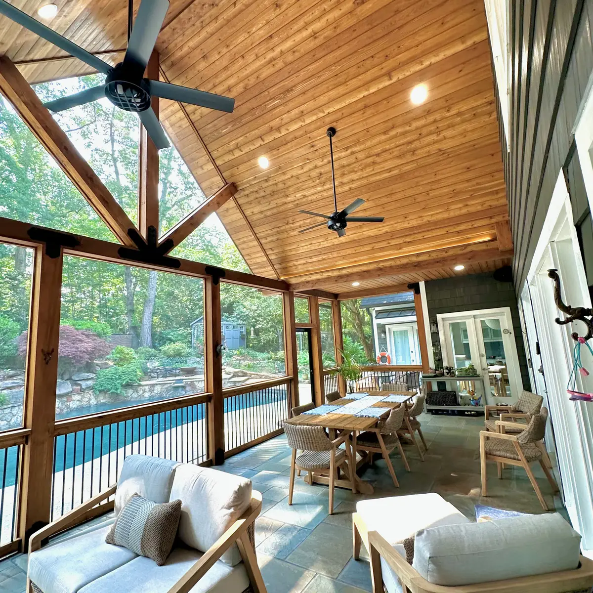 Gabled cedar screened porch overlooking a pool