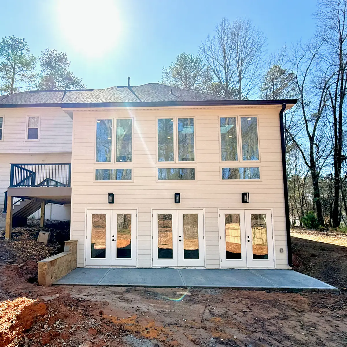 Two-story addition with tall windows and French doors