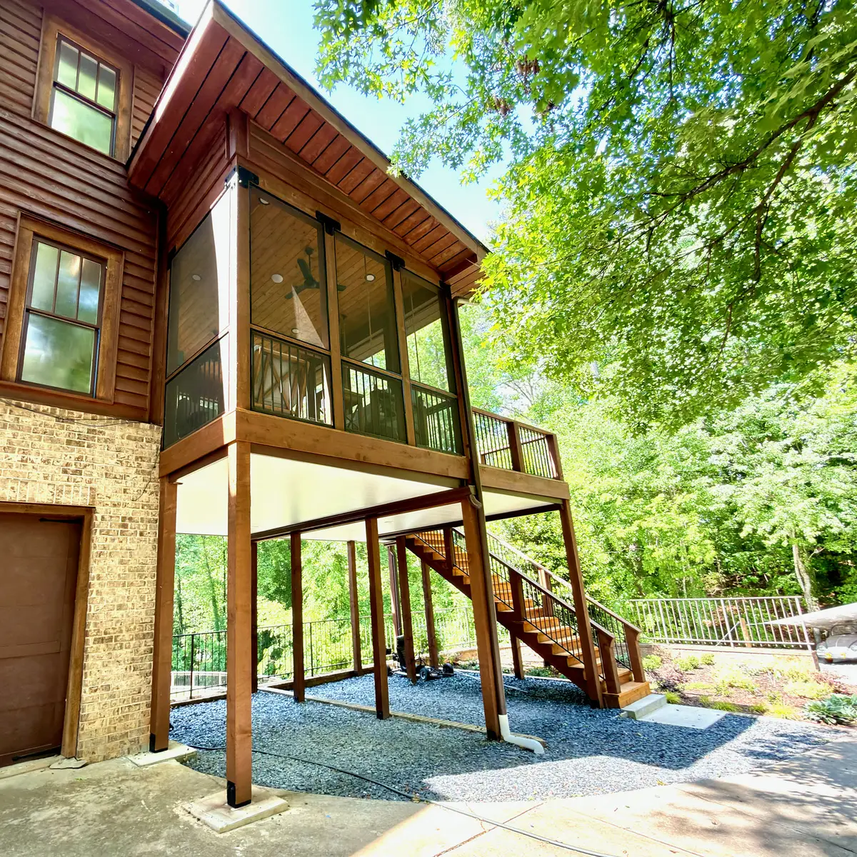 Elevated screened porch with stained wood stairs