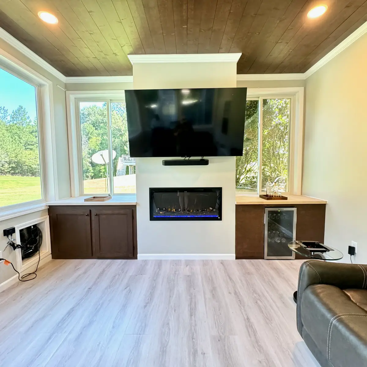 Sunroom media wall with built-ins and linear fireplace