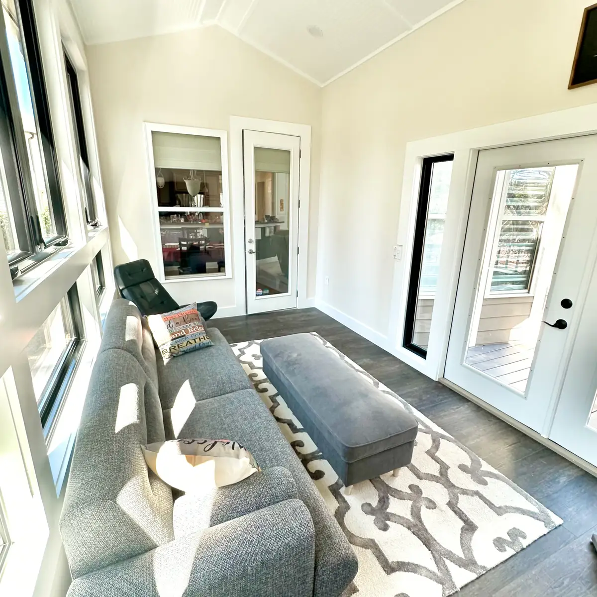 Sunroom with French doors and grey sofa
