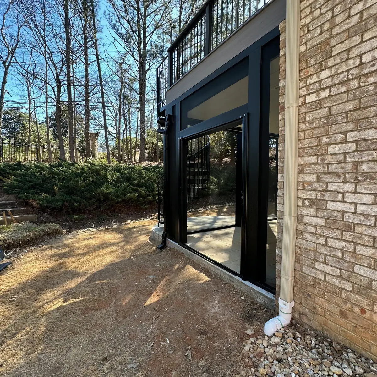 Lower-level screened patio beneath a deck