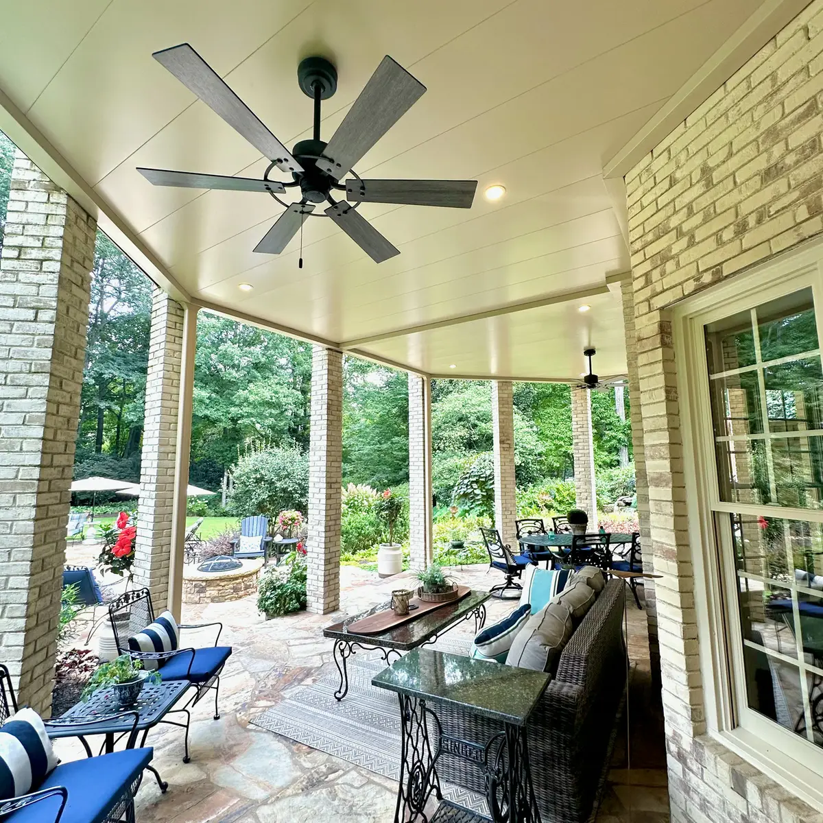 Covered flagstone patio with ceiling fan and seating