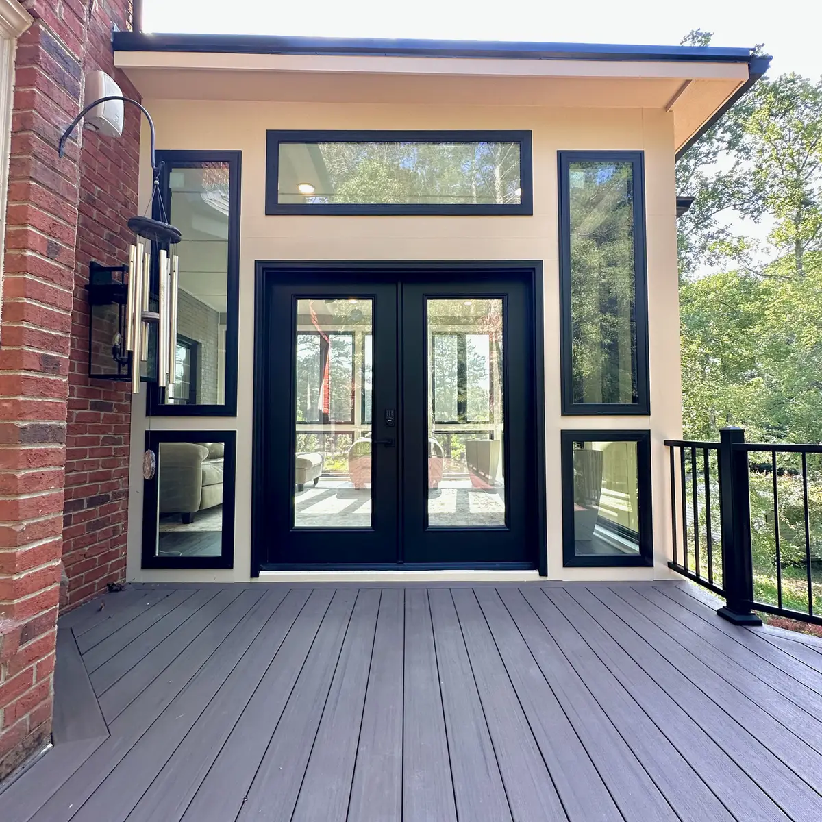 Composite deck leading to a sunroom with French doors
