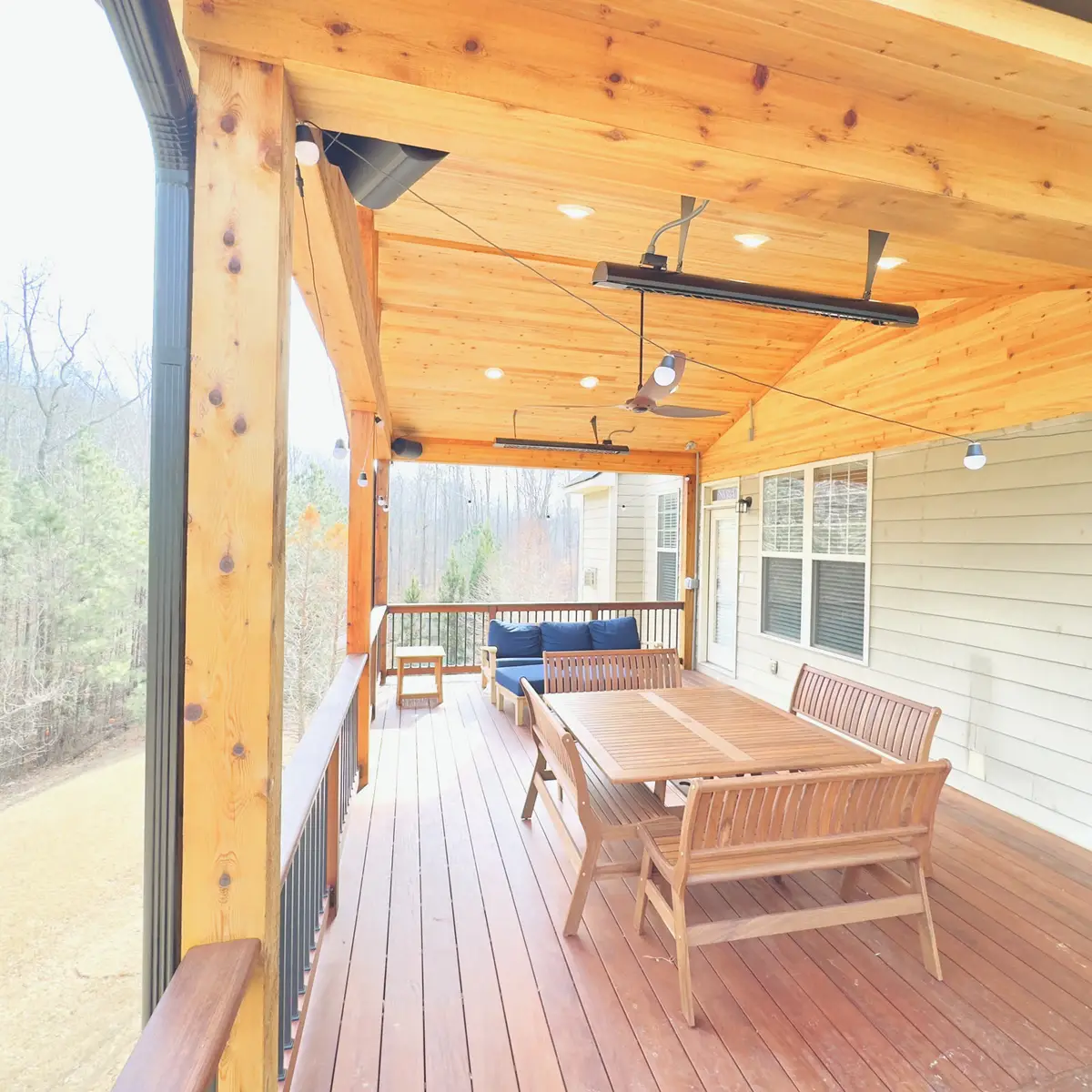 Covered deck dining area with cedar ceiling and heaters