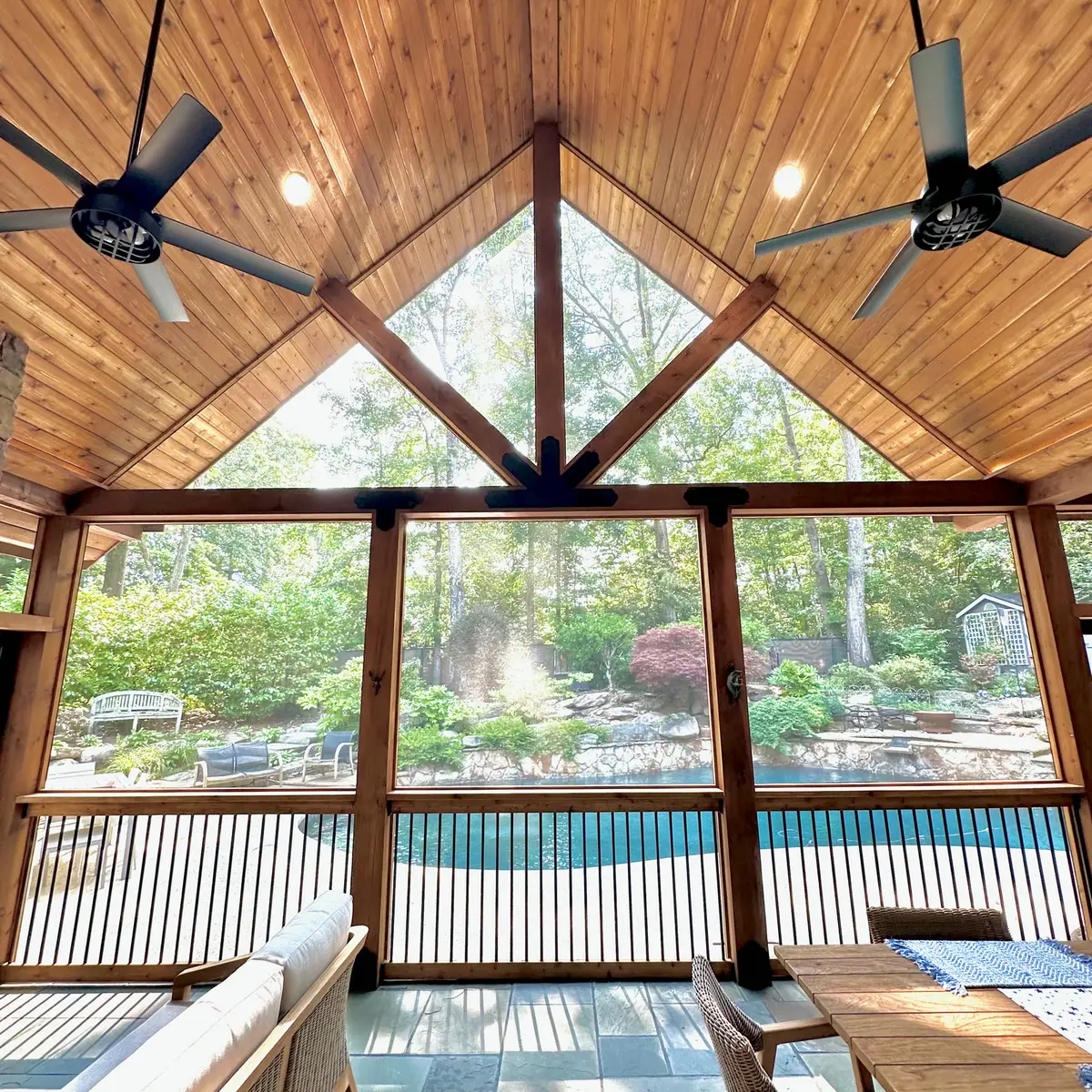 Cedar gable truss framing a screened porch pool view