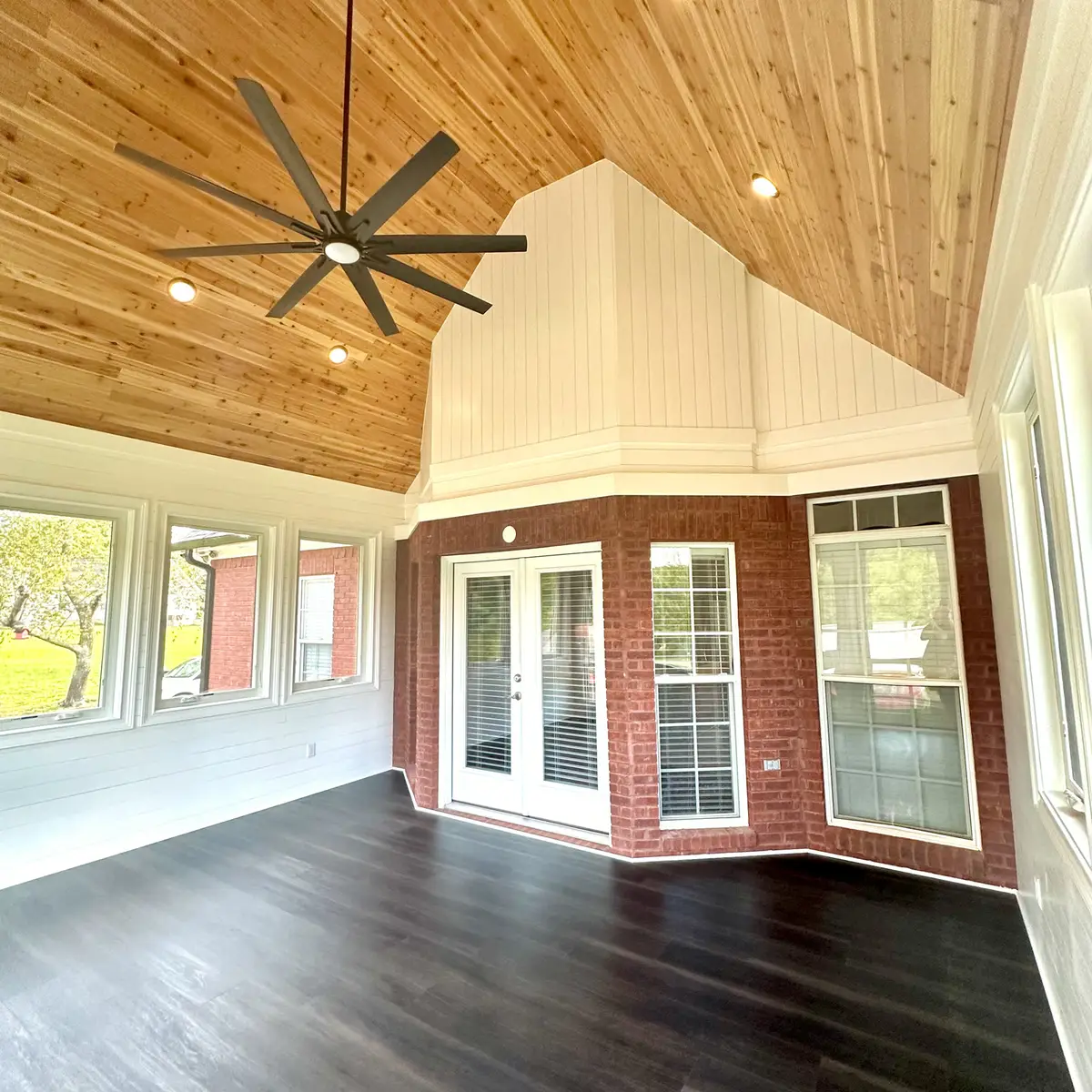 Vaulted sunroom with cedar ceiling and large fan