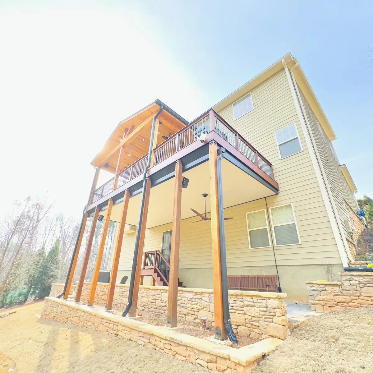 Elevated covered deck with cedar beams and stacked stone