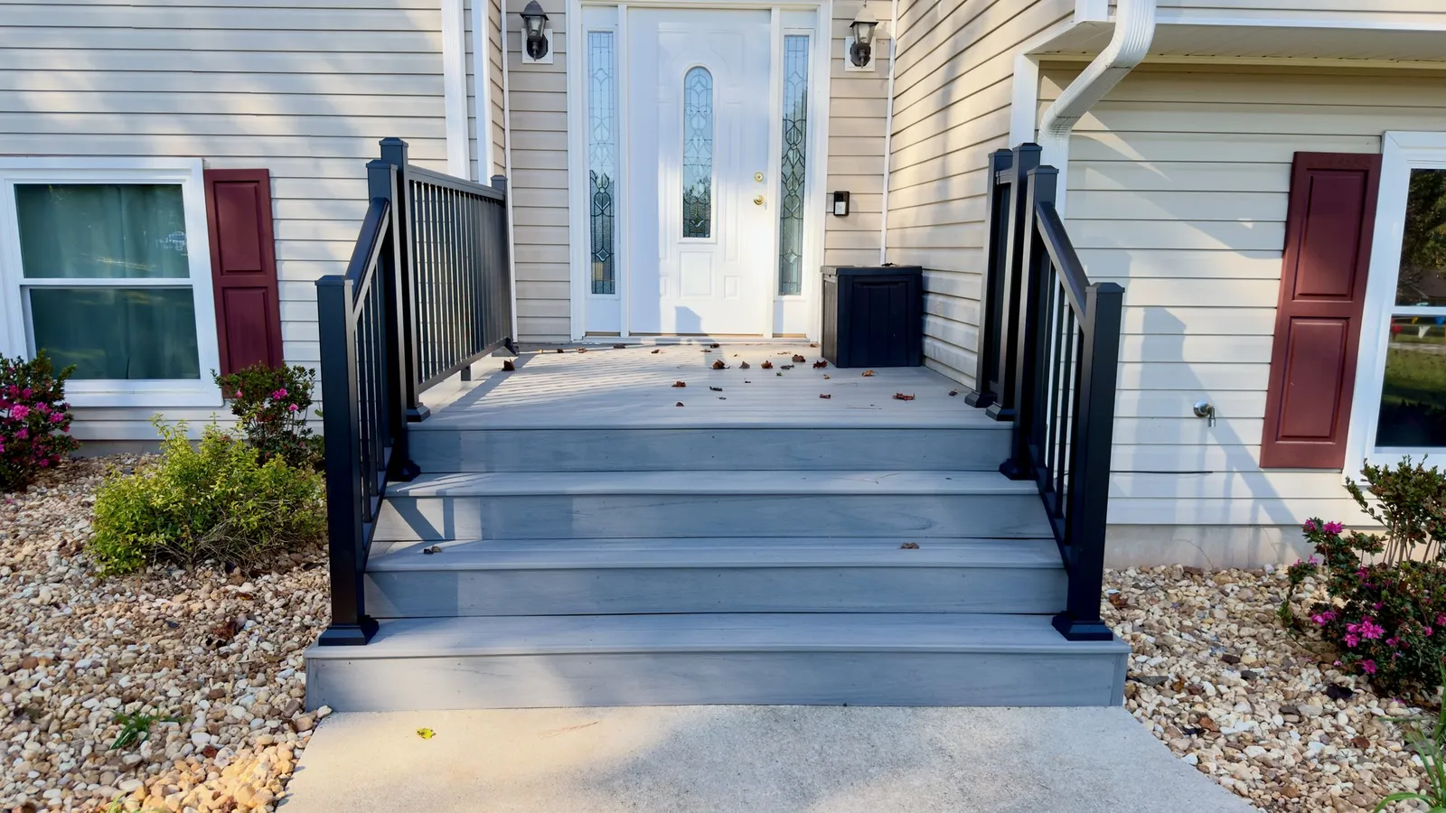 New front entry deck and steps in Sea Salt Gray composite with black aluminum rails