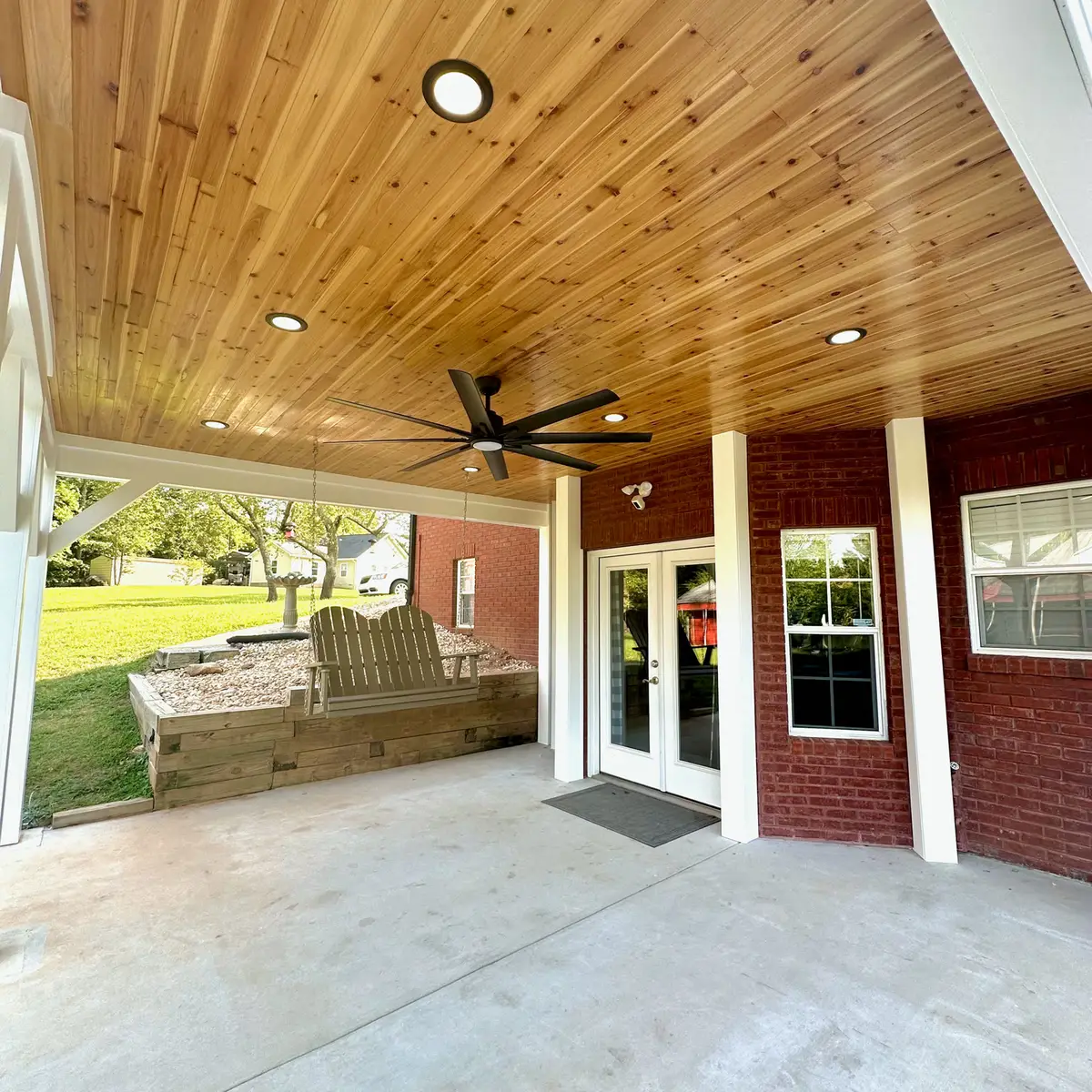 Covered porch with cedar ceiling and concrete floor
