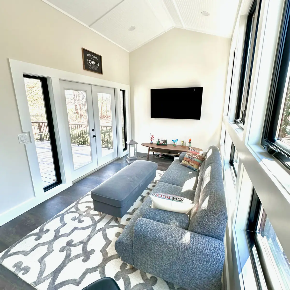 Sunroom with French doors, TV and patterned rug