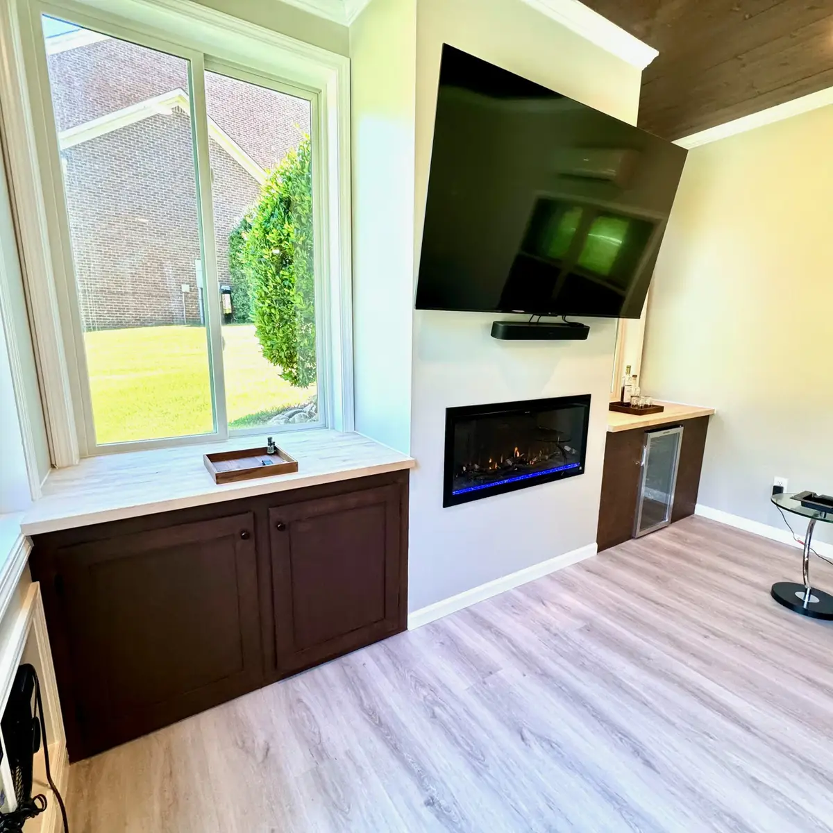 Sunroom built-in cabinets with electric fireplace and TV