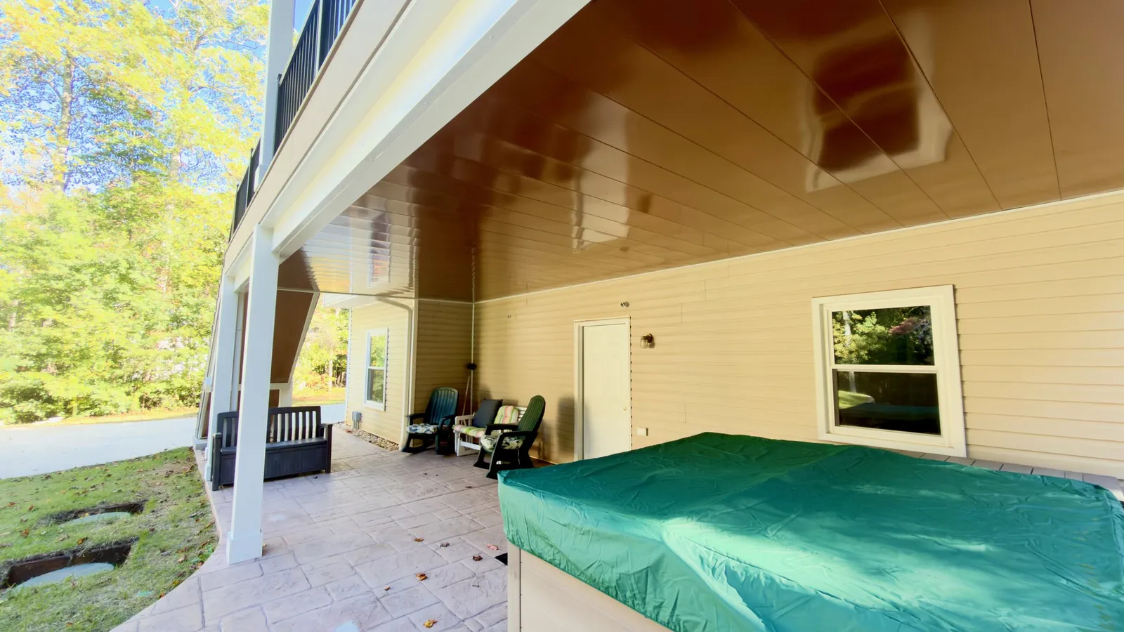 Under the deck: the copper-tone aluminum drainage ceiling over the seating area and hot tub