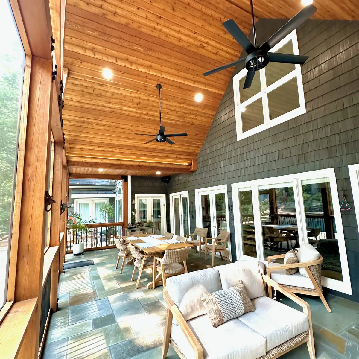 Screened porch lounge and dining under a cedar ceiling