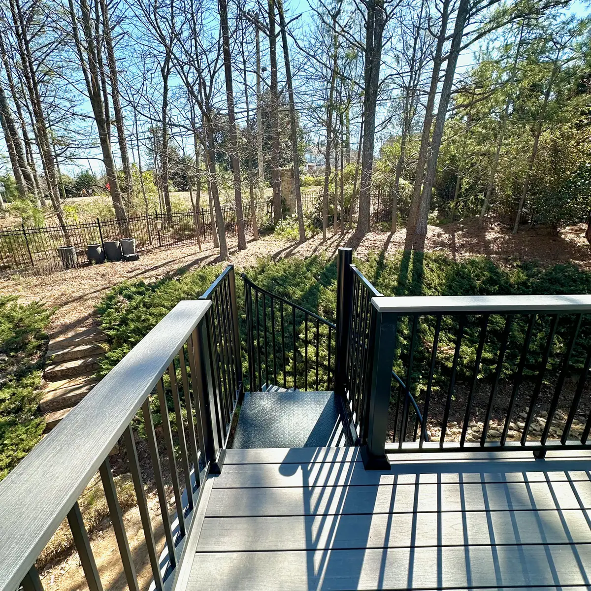 Composite deck stairs with black aluminum railings