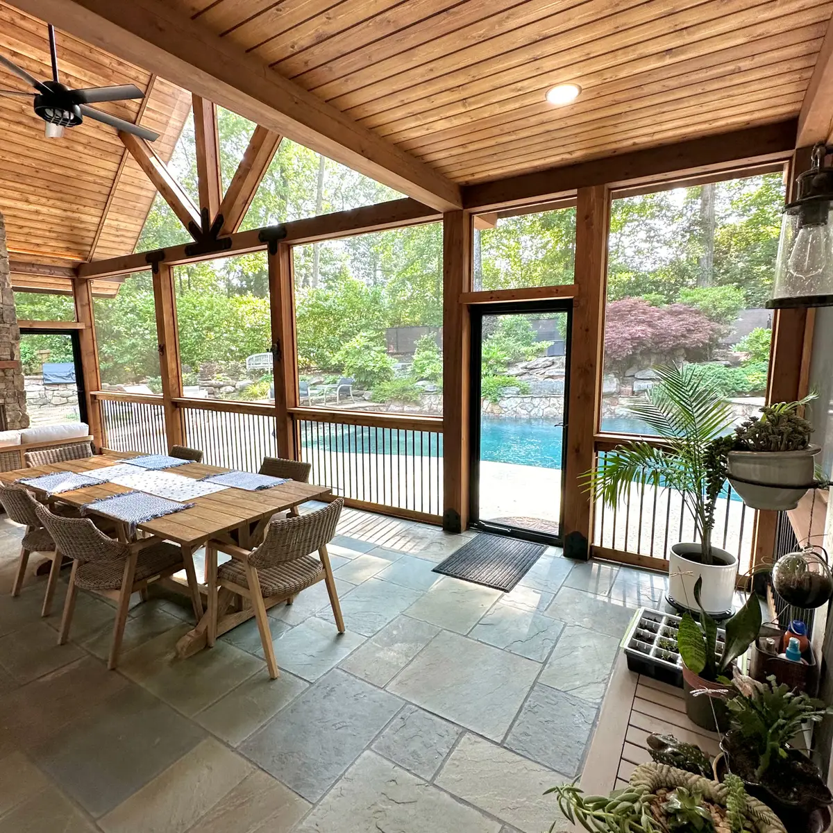 Screened porch dining area overlooking a pool