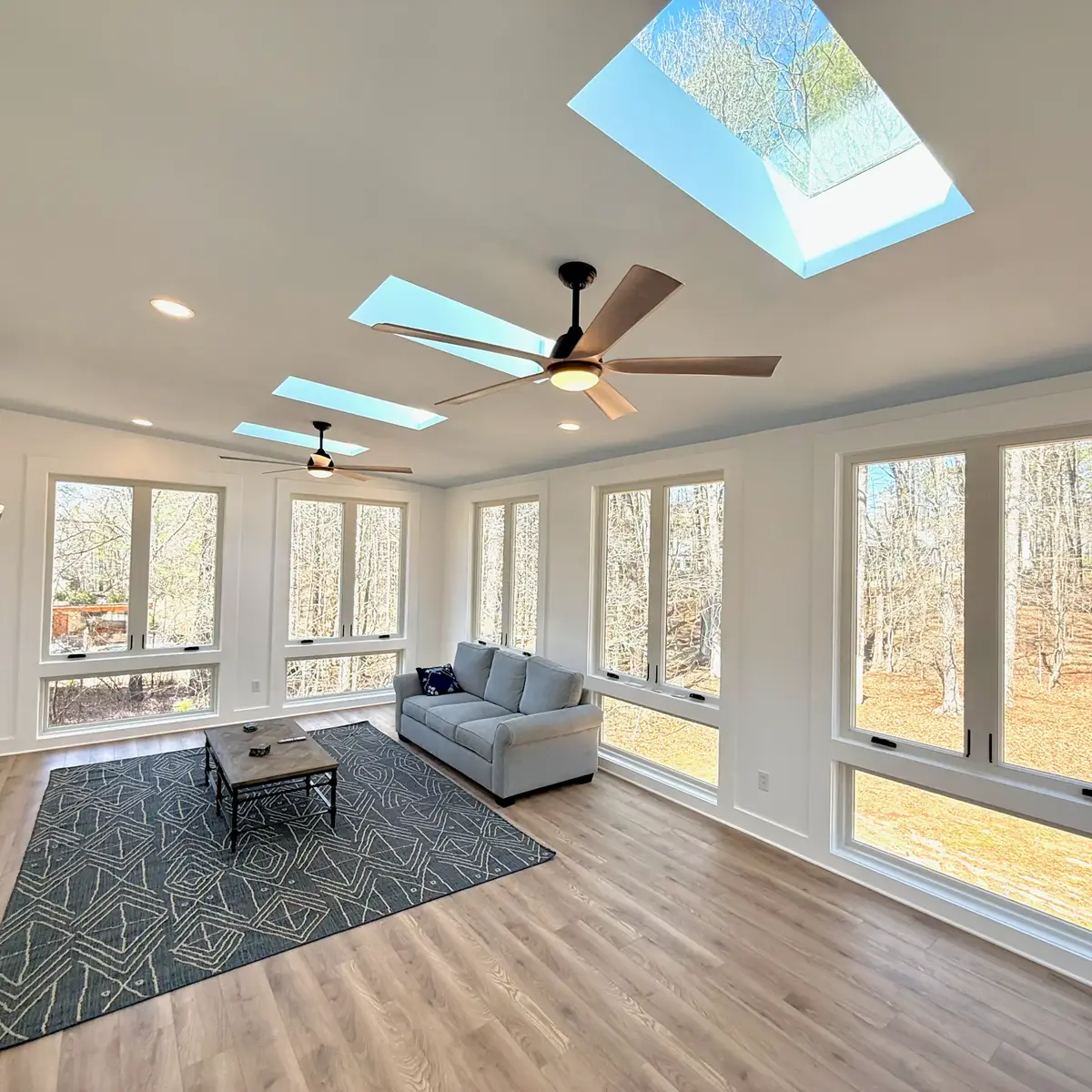 Skylights and ceiling fans in the Fayetteville sunroom with views into the trees