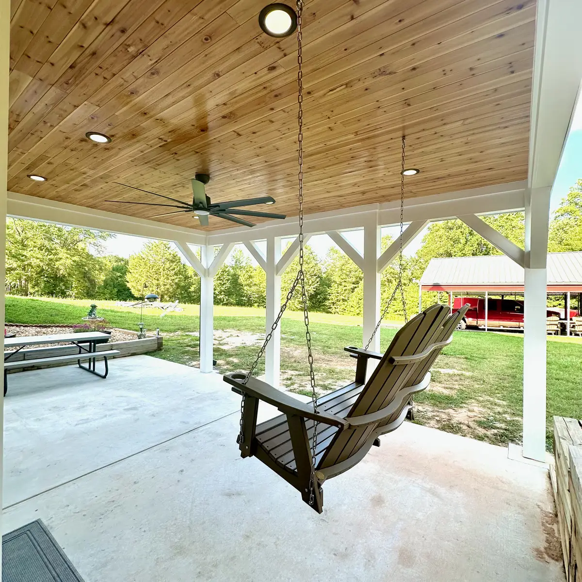 Covered porch with cedar ceiling and porch swing