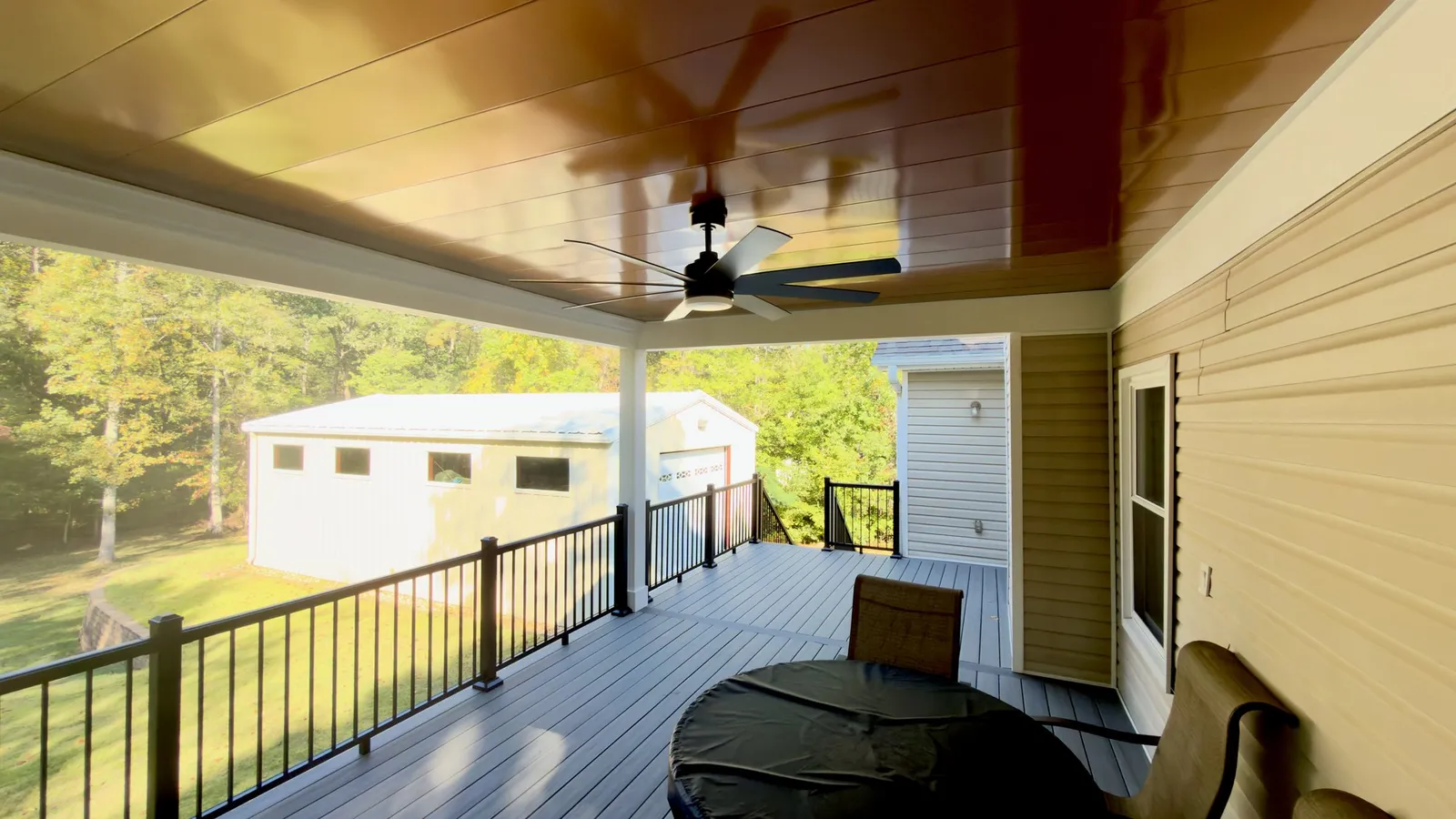 Copper-tone aluminum ceiling and fan over the Sea Salt Gray composite deck