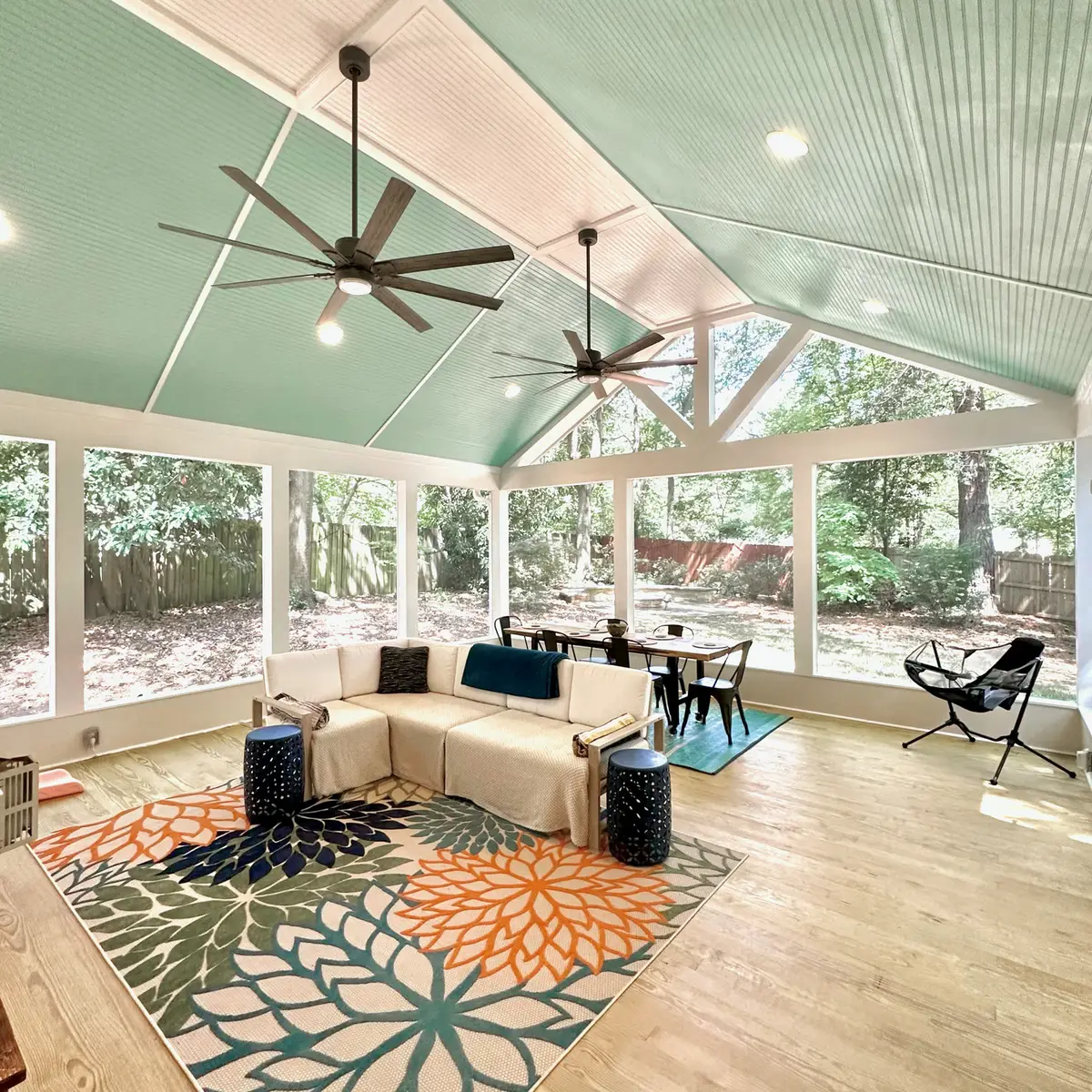 Vaulted screened porch with pine flooring and outdoor rug